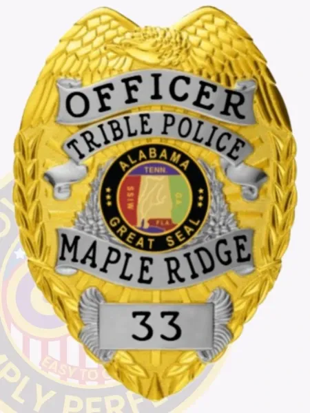 A custom metal badge in gold, designed for tribal police officers. The badge prominently features the title 'OFFICER TRIBE POLICE' at the top and 'MAPLE RIDGE' below, with a decorative banner displaying the Great Seal of Alabama at the center. The badge is adorned with intricate eagle wing details and the number '33' at the bottom, highlighting its official and personalized design.