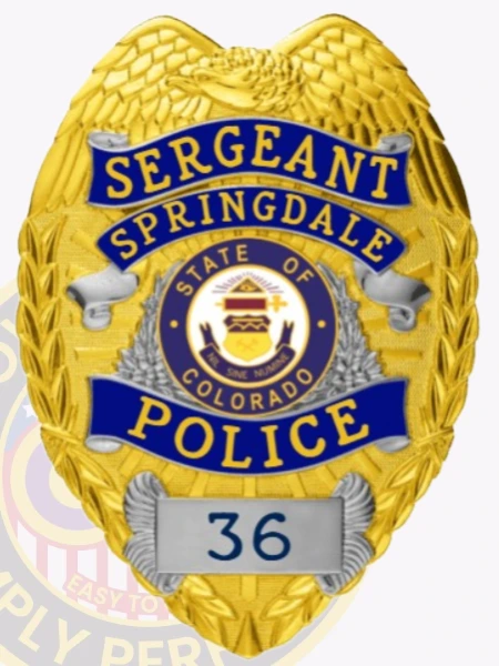 A custom metal badge in gold with silver panels featuring the words "SERGEANT" and "SPRINGDALE" at the top. The badge displays the emblem of Colorado's state seal in the center, surrounded by decorative silver laurel leaves. The word "POLICE" is prominently displayed in blue at the bottom, with the number "36" in a silver panel below it. The badge has a textured gold background and ornate wing-shaped designs at the top.