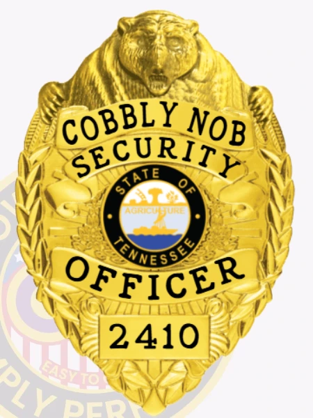 An intricate image of a custom metal badge in gold color with safety pin attachment, highlighting the "Cobbly Nob Security" lettering and the designation "SECURITY OFFICER." The badge's shiny surface and detailed decorations make it a striking symbol of authority.