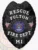 This bold custom metal badge in black color features a safety pin attachment for secure wear. It prominently displays "RESCUE FULTON" along with "FIRE DEPT." and the state emblem of Michigan, symbolizing dedication to community service.