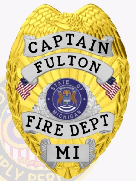 This eye-catching custom metal badge in gold color with silver panels offers a safety pin attachment for convenience. It displays "CAPTAIN FULTON," "FIRE DEPT.," and the state emblem, honoring the bravery and commitment of firefighters throughout the years.
