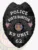 Alt Text: A bold custom metal badge all black with white lettering, shaped like a shield and featuring intricate textures. The badge displays "POLICE" at the top and "NORTH HAMPTON" beneath it in prominent white letters. In the center, the state seal of Utah is shown within a circular design, flanked by two small American flags. Below the seal, "K9 UNIT" is inscribed in white, and the number "62" is displayed at the bottom on a black panel. The matte black finish of this custom metal badge all black with white lettering enhances its professional and authoritative presence, representing the dedication of K9 officers in law enforcement.