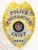 A striking custom metal badge gold with silver panels, shaped like a shield and featuring intricate detailing. The badge prominently displays "POLICE" at the top, followed by "NORTH HAMPTON" in bold black letters on a silver panel. In the center, the state seal of Utah is encircled by a decorative silver border, showcasing its design. Below the seal, the word "CHIEF" is written in bold letters, and four stars are displayed at the bottom. The combination of the shiny gold finish and silver accents of this custom metal badge gold with silver panels emphasizes its authority and prestige in law enforcement.