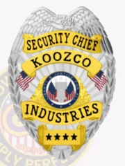 This custom metal badge in silver color is enhanced with gold panels and equipped with a safety pin attachment. It features "SECURITY CHIEF" prominently at the top and "KOOZCO INDUSTRIES" in bold lettering, framed by intricate designs and vibrant red and blue accents that signify its important role in security operations.