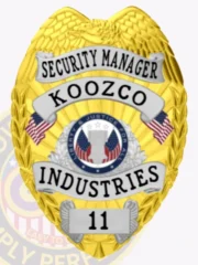 Custom metal badge in gold color featuring silver panels and a safety pin attachment, designed with an eagle emblem at the top. The badge prominently displays the words "SECURITY MANAGER" above "KOOZCO" in bold lettering. Below, it includes "INDUSTRIES" and the number "11," with decorative red and white elements and a circular seal at the center, symbolizing authority and trust.