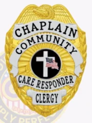 Featuring a custom metal badge in gold color with silver panels and a safety pin attachment, this badge highlights "CHAPLAIN," "COMMUNITY," and "CARE RESPONDER." The centerpiece showcases a prominent black circle with a decorative cross, illustrating commitment and support.