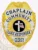 Featuring a custom metal badge in gold color with silver panels and a safety pin attachment, this badge highlights "CHAPLAIN," "COMMUNITY," and "CARE RESPONDER." The centerpiece showcases a prominent black circle with a decorative cross, illustrating commitment and support.