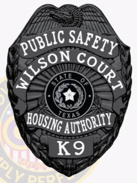 Presented is a custom metal badge in a bold black color, featuring the inscription "PUBLIC SAFETY" and "HOUSING AUTHORITY." The safety pin attachment ensures secure wear, making it suitable for those in public service who value both functionality and style.