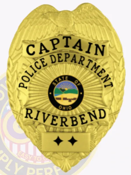 Polished custom gold metal badge showing a detailed eagle on top for Riverbend Police Captain, black lettering "CAPTAIN POLICE DEPARTMENT RIVERBEND," Ohio state insignia in the center, two black stars at the base, and safety pin on the back.