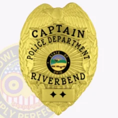 Custom gold metal badge for riverbend police captain featuring a raised eagle crest at the top, bold black text around the ohio state seal reading "captain police department riverbend," with two black stars on a gold plate below and a safety pin fastening on the reverse.