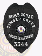 Featuring a custom metal badge in a polished black finish, this design prominently displays "BOMB SQUAD" and "TIMBER CREEK." The central emblem represents Colorado, encircled by "POLICE DEPARTMENT" with badge number "3344." A safety pin attachment allows for practical and secure wear.