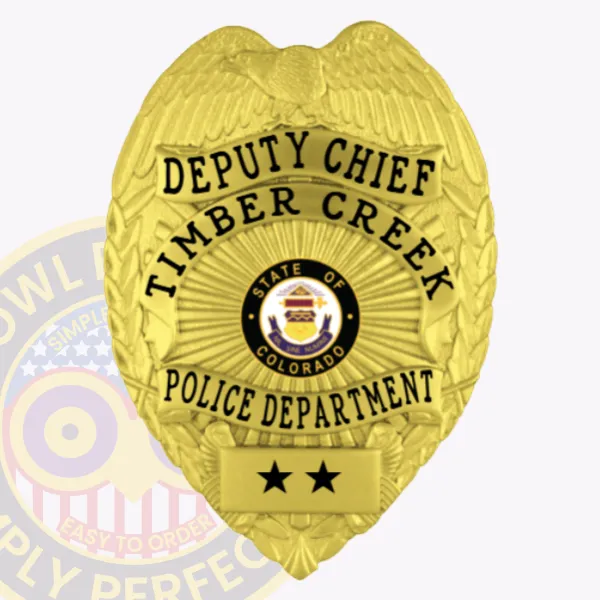 A custom metal badge in a radiant gold color, prominently displaying the title "DEPUTY CHIEF" at the top and "TIMBER CREEK" below. The badge features the state emblem of Colorado within a circular design, along with "POLICE DEPARTMENT" at the bottom. It includes a safety pin attachment for secure and convenient wear on uniforms.