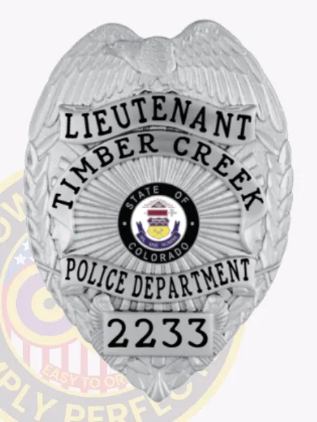 A distinctive custom metal badge in glossy silver showcases the title "LIEUTENANT" and "TIMBER CREEK." The center features the emblem of Colorado, encircled by "POLICE DEPARTMENT" and identification number "2233." It is equipped with a safety pin attachment for convenient application on various clothing items.