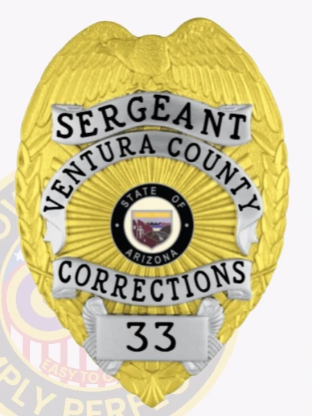 A custom metal badge featuring a combination of gold and silver colors, designed in the shape of a shield, representing the Ventura County Corrections. The badge displays "SERGEANT" prominently at the top, followed by "VENTURA COUNTY" and "CORRECTIONS" across the center. In the middle, it features the state seal of Arizona, surrounded by decorative elements. The badge is numbered "33" at the bottom and includes a safety pin attachment on the back, ensuring secure wear by correctional staff, highlighting its significance and dual-tone design.