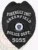 Greenfield Police Forensics Unit custom black metal badge, showing a detailed eagle with wings spread at the top, bold white lettering around the Massachusetts emblem, labeled “FORENSICS UNIT” and numbered “5055,” attached with a safety pin.