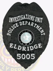 Black metal badge designed for Eldridge Police Investigations Unit, showing a detailed eagle crest at the top, white engraved text stating “POLICE DEPARTMENT ELDRIDGE INVESTIGATIONS UNIT,” centered Texas state seal, and number “5005” at the base, with safety pin attachment.