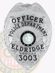Polished custom silver metal badge for Eldridge Police Officer, featuring an eagle at the crest, black text reading "OFFICER POLICE DEPARTMENT ELDRIDGE," with the Texas state seal in the center and numbered "3003," equipped with a safety pin attachment.