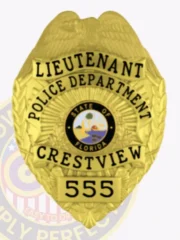 Gold metal badge for Crestview Police Lieutenant with an eagle emblem at the top, black engraved text reading "LIEUTENANT POLICE DEPARTMENT CRESTVIEW," centered Florida state seal, and badge number "555" on a gold plate at the bottom, fastened with a safety pin.
