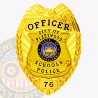 Gold custom metal badge showcasing a detailed eagle motif and the title "OFFICER" at the top. The center contains a circular state seal for Pennsylvania, with surrounding text that reads "CITY OF FLEETWOOD SCHOOLS POLICE" and the number "76." This badge has a safety pin attachment, designed for easy wear.
