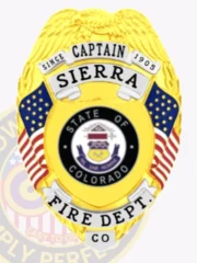 This distinguished custom metal badge in gold color features silver panels and a safety pin attachment for secure fastening. It prominently displays "CAPTAIN SIERRA" along with "FIRE DEPT." and the state emblem of Colorado, symbolizing dedication to community service since 1905.