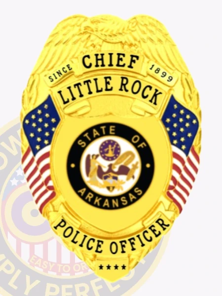 A vibrant custom metal badge gold, shaped like a shield with detailed engravings. The badge displays "CHIEF" at the top, followed by "LITTLE ROCK" and "SINCE 1899" in prominent lettering. In the center, the state seal of Arkansas is encircled by a decorative black ring, showcasing its intricate design. Flanking the seal are two small American flags, and below, "POLICE OFFICER" is clearly inscribed in bold letters. The shiny gold finish of this custom metal badge gold highlights its authority and professionalism, making it a distinguished symbol of law enforcement pride.