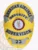 Striking gold badge adorned with sophisticated silver panels, showcasing the inscription "AMERICAN AIRLINES SECURITY SUPERVISOR." The badge includes a central emblem representing the airline and features a safety pin attachment for practical wear. This custom metal badge in gold color with silver panels and safety pin attachment represents dedication and leadership in the security field.