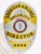 Shiny silver badge adorned with bold gold panels, prominently displaying "AMERICAN AIRLINES SECURITY DIRECTOR" along with an emblem of the airline. The practical safety pin attachment ensures it remains securely fastened, making it suitable for daily wear. This custom metal badge in silver color with gold panels and safety pin attachment represents commitment to excellence in security.