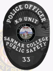 A custom police badge in black, prominently displaying the title "POLICE OFFICER" at the top and "K9 UNIT" just below it. The badge features the emblem for the "STATE OF IOWA" at its center, surrounded by the text "SANMAR COLLEGE PUBLIC SAFETY." At the bottom, the badge number "33" is shown, emphasizing its sleek and official black design.