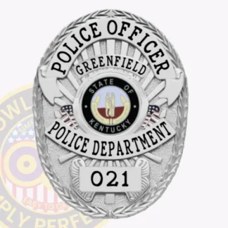 This stylish custom metal badge in silver showcases a refined oval shape adorned with intricate details. The title "POLICE OFFICER" is featured prominently at the top in bold black letters, with "GREENFIELD" directly below. The center displays the Greenfield Police Department logo, surrounded by "STATE OF KENTUCKY." A safety pin attachment provides an easy way to secure the badge.