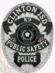 A detailed police badge in silver with black panels, featuring the text 'CLINTON ISD K9' at the top. The badge showcases 'PUBLIC SAFETY POLICE' prominently, with the state emblem of Texas at its center. The design includes intricate details and contrasting black panels, enhancing its authoritative appearance and highlighting its significance in law enforcement.