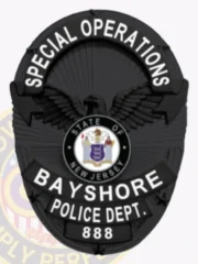 Oval black metal badge designed for Bayshore Police special operations, showing a detailed black eagle in the center, curved black ribbons with bold white text stating "SPECIAL OPERATIONS" on top and "BAYSHORE POLICE DEPT." underneath, including the New Jersey state emblem and the number 888.