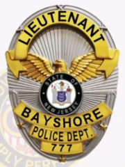 Custom silver oval metal badge for Bayshore police the lieutenant with safety pin attachment, featuring a gold eagle at center, black and gold text reading "LIEUTENANT" on top, "BAYSHORE POLICE DEPT." in the middle, and badge number "777" at the bottom, with the State of New Jersey seal in the center.