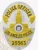 Oval-shaped custom metal badge for LAPD, displaying a detailed gold city hall emblem on a silver background with sunburst pattern, with yellow banners above and below stating POLICE OFFICER and LOS ANGELES POLICE, plus a gold-yellow plate showing the badge number 25563, equipped with safety pin for easy attachment.