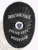 Black oval custom metal badge for Westfield police drug task force with safety pin back, displaying embossed laurel leaves around the border, white uppercase text on black banners for "DRUG TASK FORCE," "POLICE DEPT.," and "WESTFIELD," featuring the official Massachusetts state seal.