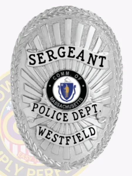 Oval silver metal badge designed for Westfield Police sergeant with safety pin attachment, showing an embossed laurel wreath edge and radiant sunray pattern, silver scrolls with bold black lettering stating "SERGEANT," "POLICE DEPT.," and "WESTFIELD," surrounding the Massachusetts state emblem.