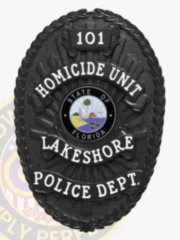 Lakeshore Police Department black oval metal badge for homicide unit, highlighted by a raised laurel leaf border and sunray pattern in black, white bold text reading "101," "HOMICIDE UNIT," "LAKESHORE," and "POLICE DEPT.," with the State of Florida seal prominently displayed in the center.