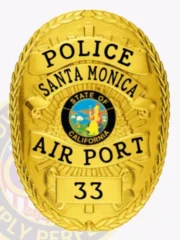 A custom metal badge in all gold, prominently displaying the word "POLICE" at the top, followed by "SANTA MONICA" and "AIR PORT" beneath it. The badge features the emblem for the "STATE OF CALIFORNIA" at its center, with the badge number "33" at the bottom. Its shiny gold finish reflects authority and professionalism, highlighting its detailed craftsmanship.