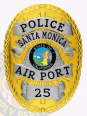 A custom metal badge in gold with silver panels, featuring the word "POLICE" at the top, followed by "SANTA MONICA" above the central emblem. The badge displays the "STATE OF CALIFORNIA" emblem in the center, with "AIR PORT" below it and the badge number "25" at the bottom. The combination of gold and silver elements highlights its distinguished design and authoritative presence.