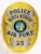 A custom metal badge in gold with silver panels, featuring the word "POLICE" at the top, followed by "SANTA MONICA" above the central emblem. The badge displays the "STATE OF CALIFORNIA" emblem in the center, with "AIR PORT" below it and the badge number "25" at the bottom. The combination of gold and silver elements highlights its distinguished design and authoritative presence.