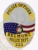 Silver custom oval metal badge for Belmont Police Officer featuring an eagle embossed at the top over an American flag and Alabama state seal, accented by yellow text banners with "POLICE OFFICER," "BELMONT," "POLICE DEPT.," and badge number "222," attached with a safety pin.
