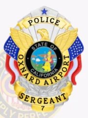 A custom metal badge in silver with gold panels featuring the title “POLICE” prominently at the top. The badge has a sleek silver design accented with gold elements, including an eagle emblem at the top and colorful blue and red details on either side. In the center, a circular seal represents the “STATE OF CALIFORNIA,” showcasing a vibrant scene. Below the seal, the words “OXNARD AIRPORT SERGEANT” are clearly visible, along with the badge number “7.” The combination of silver and gold enhances the badge's official and prestigious appearance, making it a striking symbol of law enforcement.
