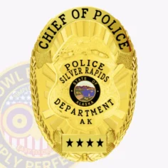 A beautifully crafted custom metal badge in gold that reads "chief of police" at the top and "police silver rapids" at the center. The design includes an emblem for "state of alaska," with "department ak" and four stars noted below. Featuring a sturdy safety pin attachment, this badge provides secure placement on uniforms for law enforcement professionals.