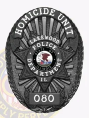 Featuring a polished look, this custom metal badge in black includes a striking star pattern. The top reads "HOMICIDE UNIT," while the center showcases "LAKEWOOD POLICE DEPARTMENT" along with the Illinois state emblem, and "IL" below, all attached easily with a reliable safety pin closure.