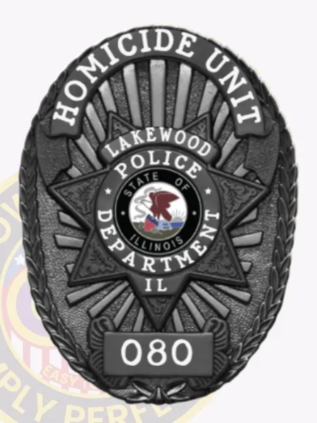 Featuring a polished look, this custom metal badge in black includes a striking star pattern. The top reads "HOMICIDE UNIT," while the center showcases "LAKEWOOD POLICE DEPARTMENT" along with the Illinois state emblem, and "IL" below, all attached easily with a reliable safety pin closure.