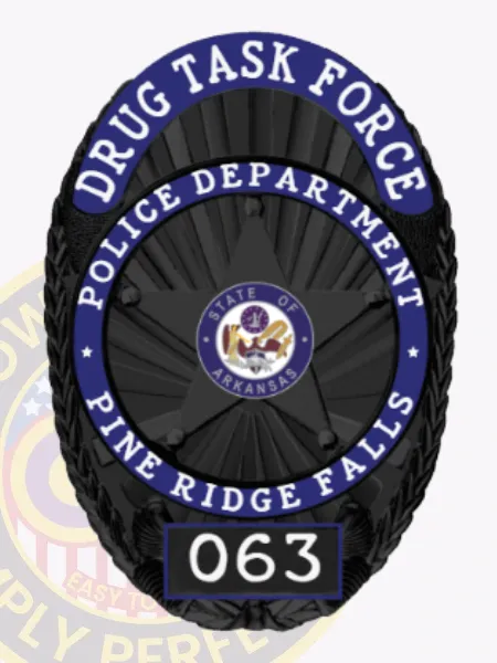 A striking custom metal badge in black with blue reverse enamel panels, prominently displaying "DRUG TASK FORCE" at the top and "POLICE DEPARTMENT PINE RIDGE FALLS" below. The badge showcases a star design with an emblem for "STATE OF ARKANSAS," along with "063" at the bottom. With its safety attachment, this badge ensures secure and effortless fastening to any uniform or clothing.