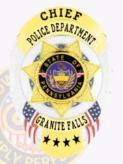 A custom metal badge in silver with gold panels and a safety pin attachment, prominently displaying "CHIEF" at the top. Below, "POLICE DEPARTMENT" is elegantly inscribed, with a star design featuring the state seal of Pennsylvania at its center. The badge's shiny silver finish is complemented by vibrant gold accents, creating an authoritative and distinguished appearance.