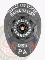 A striking custom metal badge in black that prominently displays "SEARCH AND RESCUE" across the top and "Maple Valley" below it. The center showcases a star design featuring "POLICE DEPARTMENT," along with the numbers "053" and "PA" at the bottom. This badge comes with a safety pin attachment, allowing for easy fastening to uniforms or clothing for law enforcement professionals.