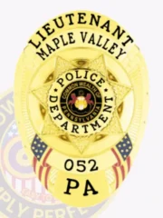 A gleaming custom metal badge in gold, featuring the title "LIEUTENANT" prominently at the top, followed by "Maple Valley" just below. The center of the badge showcases a star design with "POLICE DEPARTMENT" encircled around a central emblem. The badge is adorned with "052" and "PA" at the bottom and includes a safety pin attachment for secure fastening on uniforms.