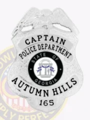 Shiny silver shield-shaped metal badge for Autumn Hills Police Department captain featuring an eagle perched on top, black embossed text, the official State of Georgia emblem in the center, and a safety pin for secure fastening.