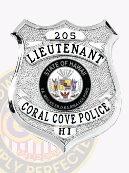 Detailed custom silver shield metal badge for Coral Cove police the lieutenant with safety pin attachment, featuring a polished silver shield with black text bands reading "LIEUTENANT," "CORAL COVE POLICE," and "HI," the Hawaii state seal in full color at the center, and "205" on a raised top panel.